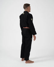 Kingz The ONE V2 LE BJJ Gi Black Green three-quarter back view showing green crown logo and sleeve patch