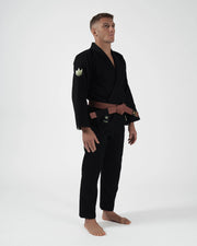 Kingz The ONE V2 LE BJJ Gi Black Green angled full body stance showing brown belt and green crown patch