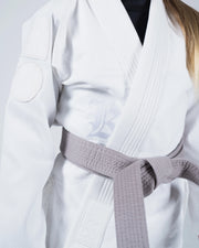 Kingz Born to Rule Youth Jiu Jitsu Gi White - Close-Up Detail View Gray Belt White Gi Textured Fabric Kingz Logo Patch on Lapel Youth BJJ Training Gi [color:White]