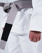 Kingz Born to Rule Youth Jiu Jitsu Gi White - Close-Up Detail View Gray Belt White Gi Textured Fabric Kingz Logo Patch on Lapel Youth BJJ Training Gi [color:White]