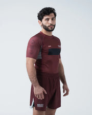 Kingz Trooper Rashguard Maroon - Full Body Front View Male Athlete Short Sleeve KINGZ Logo Black Chest Band Flag Patch Sunburst Design Maroon Shorts