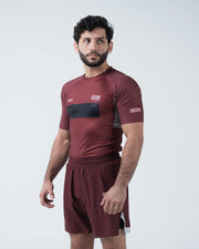Kingz Trooper Rashguard Maroon - Full Body 3/4 Angled Front View Male Athlete Short Sleeve KINGZ Logo Black Chest Band Flag Patch Right Side View
