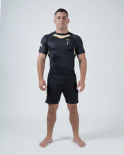 Kingz Player Special Limited Edition Rashguard Black - Full Body Front View Male Athlete Short Sleeve Gold Accents KINGZ Text Left Sleeve Crown Logo Chest Athletic Fit BJJ No-Gi Grappling Rash Guard [color:Black]