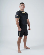 Kingz Player Special Limited Edition Rashguard Black - Full Body Front View Male Athlete Black Gold Accents Shoulder Logo Text Right Sleeve Crown Chest Fitted Design BJJ No-Gi Rash Guard [color:Black]