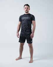 Kingz Acid Wash Rashguard Black - Full Body Straight Front View Barefoot Male Athlete Short Sleeve KINGZ White Outline Bold Text Acid Wash Black Dot Pattern Shorts BJJ Training