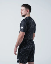 Kingz Acid Wash Rashguard Black - Full Body Left Side Profile View Male Athlete Short Sleeve Crown Logo Acid Wash Dot Pattern Matching Shorts KINGZ Text Compression Fit