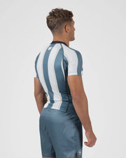 Kingz Vintage Futebol Rashguard Blue White Stripe - Full Body 3/4 Back View Right Side Male Athlete Short Sleeve Crown Logo Back Vertical Stripes Gray Shorts Retro Football Kit