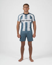 Kingz Vintage Futebol Rashguard Blue White Stripe - Full Body Front View Male Athlete Looking Away Short Sleeve Retro Football Kit Crest Badge Cursive Text Gray Shorts