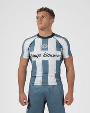 Kingz Vintage Futebol Rashguard Blue White Stripe - Full Body Front View Male Athlete Short Sleeve Retro Football Kit Vertical Stripes Cursive Kingz Kimonos Text Gray Blue Shorts