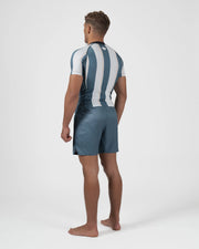 Kingz Vintage Futebol Rashguard Blue White Stripe - Full Body Back View Barefoot Male Athlete Short Sleeve Vertical Stripes Back Panel Logo Gray Shorts Retro Football Kit