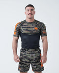 Kingz Always Hunting Rashguard Green Camo - Full Body Front View Male Athlete Short Sleeve Tiger Camo Pattern Orange Crown Logo Orange Accents Matching Camo Shorts