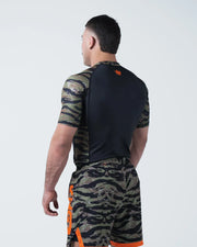 Kingz Always Hunting Rashguard Green Camo - Full Body Back View Male Athlete Short Sleeve Tiger Camo Sleeves Orange Crown Logo Upper Back Black Back Panel Camo Shorts KINGZ Text