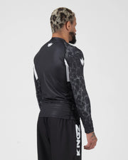 Kingz Ranked Performance V3 L/S Rashguard Black - Full Body 3/4 Back View Left Side Male Athlete Long Sleeve Crown Logo Patterned Dot Sleeves White Arm Panels KINGZ Shorts