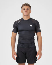 Kingz Ranked Performance V3 S/S Rashguard Brown - Full Body Front View Male Athlete Short Sleeve Crown Logo Brown Orange Dot Pattern Shoulders KINGZ Performance Label IBJJF