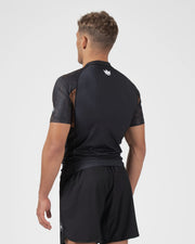Kingz Ranked Performance V3 S/S Rashguard Brown - Full Body Back View Male Athlete Short Sleeve Crown Logo Upper Back Brown Orange Dot Pattern Sleeves Black Shorts