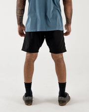 Kingz Casual Gi Shorts - Black - Back View Male Athlete Solid Black Relaxed Fit Above Knee Length Minimalist Design Grappling Shorts BJJ Training [color:Black]