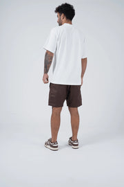 Kingz Casual Gi Shorts Brown Dark Chocolate - Full Body Front View Arms at Sides Male Athlete Dark Brown Ripstop Casual Shorts Drawstring Waistband Black Woven Kingz Label Right Thigh White T-Shirt Brown Nike Dunk Sneakers Men's BJJ Lifestyle [color:Earthy brown]