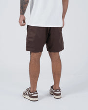 Kingz Casual Gi Shorts Brown Dark Chocolate - Full Body Front View Hands on Drawstring Male Athlete Dark Brown Ripstop Casual Shorts Black Woven Kingz Label Right Thigh White T-Shirt Brown Nike Dunk Sneakers Men's BJJ Lifestyle [color:Earthy brown]