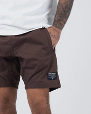 Kingz Casual Gi Shorts - Brown - Partial Body Side View Male Athlete Earthy Brown Fabric Black Label Right Leg Relaxed Fit Grappling Shorts BJJ Training [color:Earthy brown]