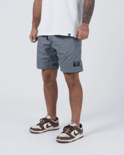 Kingz Casual Gi Shorts Grey Steel Blue-Grey - Full Body Front View Male Athlete Grey Ripstop Casual Shorts Drawstring Waistband Black Woven Kingz Label Right Thigh Elastic Hem Banding White T-Shirt Brown Nike Dunk Sneakers Men's BJJ Lifestyle [color:Grey]