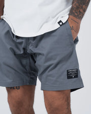 Kingz Casual Gi Shorts Grey - Close-Up Front View Male Athlete Grey Textured Fabric Black Label Right Leg Relaxed Fit Grappling Shorts BJJ Training [color:Grey]