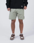 Kingz Casual Gi Shorts Sage Stone Green - Full Body Front View Male Athlete Sage Stone Green Ripstop Casual Shorts Above-Knee Cut Elastic Leg Hem Drawstring Waistband Black Woven Kingz Label Right Thigh Black Hoodie Brown Nike Dunk Sneakers Men's BJJ Lifestyle [color:Stone Green]
