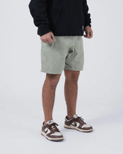 Kingz Casual Gi Shorts Sage Stone Green - Full Body Right Side Profile 3/4 View Male Athlete Sage Ripstop Casual Shorts Elastic Hem Banding Relaxed Loose Fit Below Knee Black Hoodie Brown Nike Dunk Sneakers Men's BJJ Lifestyle [color:Stone Green]