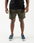 Kingz Casual Gi Shorts Military Green Dark Olive - Full Body Front View Male Athlete Dark Olive Military Green Ripstop Shorts Above-Knee Drawstring Waistband Black Woven Kingz Label Right Thigh Black T-Shirt Blue Nike Cortez Sneakers Yellow Swoosh Men's BJJ Lifestyle [color:Military Green]