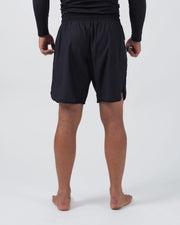 Kingz Kore V2 Shorts Black - Full Body Back View Male Athlete Black Grappling Shorts Clean Back Panel Elastic Waistband Side Vents Competition Cut Mid-Thigh Length Black KINGZ Rashguard Bare Feet Men's No-Gi BJJ MMA Kore Collection