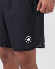 Kingz Kore V2 Shorts Black - Close Up Right Thigh Detail White Outlined Crown Logo Emblem Right Outer Thigh Side Vent Slit Hem Hand Gripping Waistband Black Lightweight Grappling Fabric Competition Cut Men's No-Gi BJJ MMA Kore Collection