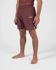 Kingz Trooper Shorts Maroon - Full Body Right Side Profile Male Athlete Maroon Burgundy KINGZ Badge Right Side Inner Compression Shorts Gray Trim Visible Competition Cut Men's Grappling Shorts No-Gi BJJ