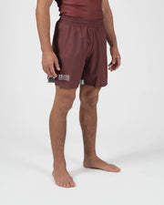 Kingz Trooper Shorts Maroon - Full Body Left Side Profile Alternate Stance Male Athlete Maroon Burgundy Flag Badge Left Leg Inner Compression Shorts Gray Visible Competition Cut Men's Grappling Shorts No-Gi BJJ