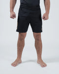 Kingz Player Special Limited Edition Shorts Black Gold - Full Body Front View Male Athlete All-Black KINGZ Gold Text Left Leg Gold Crown Badge Right Thigh Black Elastic Waistband Competition Cut Men's Grappling Shorts No-Gi BJJ Tainan Dalpra Signature Collection [color:Black]