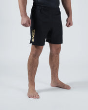 Kingz Player Special Limited Edition Shorts Black Gold - Full Body 3/4 Angled Front View Male Athlete All-Black KINGZ Gold Metallic Vertical Text Left Leg Competition Cut Men's Grappling Shorts No-Gi BJJ Limited Edition [color:Black]