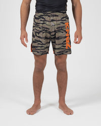 Kingz Always Hunting Shorts Green Camo - Full Body Front View Male Athlete Olive Army Green Tiger Camo Pattern KINGZ Bold Orange Text Left Leg Orange Side Accent Panels Inner Compression Shorts Orange Trim Competition Cut Men's Grappling Shorts No-Gi BJJ