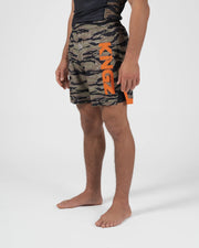 Kingz Always Hunting Shorts Green Camo - Full Body Right Side Profile Male Athlete Tiger Camo Pattern KINGZ Bold Orange Text Left Leg Orange Side Panel Lower Competition Cut Men's Grappling Shorts No-Gi BJJ