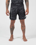 Kingz Acid Wash Shorts Black - Full Body Front View Tattooed Male Athlete Black White Dot Acid Wash Pattern KINGZ Bold Waistband Text KINGZ Large Left Leg Text Crown Badge Right Thigh Competition Cut Men's Grappling Shorts No-Gi BJJ