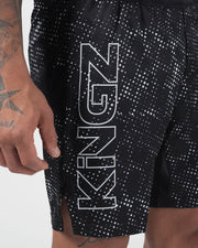 Kingz Acid Wash Shorts Black - Close Up Leg Detail KINGZ Large Outline White Hollow Text Left Leg Black Base White Dot Acid Wash Pattern Sublimated Texture Branding Detail Men's Grappling Shorts No-Gi BJJ