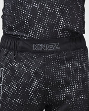 Kingz Acid Wash Shorts Black - Close Up Waistband Detail KINGZ Outline White Text Waistband Black Base White Dot Acid Wash Gradient Pattern Sublimated Fabric Texture Men's Grappling Shorts No-Gi BJJ