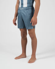 Kingz Vintage Futebol Shorts Light Blue - Full Body Right Side Profile Male Athlete Steel Blue Soccer Inspired Shorts Kingz Kimonos Script Waistband Side Split Visible Men's Grappling Shorts No-Gi BJJ