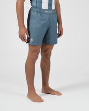Kingz Vintage Futebol Shorts Light Blue - Full Body Right Side Profile Male Athlete Kingz Kimonos Script Waistband White Crown Badge Left Thigh Steel Blue Soccer Inspired Competition Cut Men's Grappling Shorts No-Gi BJJ
