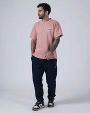 Kingz Gentle Art Club Tee - Full Body Lifestyle Front - Muted Pink Oversized Tee Worn With Dark Pants - BJJ