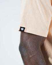 Kingz Jiu Jitsu Motion Tee - Crown Label Close-Up - Woven Crown Tag on Peach Fabric - BJJ Premium Tee