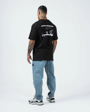 Kingz Solo Tee - Full Back Lifestyle View - Kingz Kimonos BJJ Photo Print Est 2011 Worn With Jeans - Black