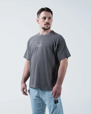 Kingz Box Tee - Front Three Quarter Angle - KINGZ Box Label Chest Worn With Light Wash Jeans - Grey BJJ Tee