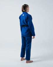 Kingz Kore V2 Women's BJJ Gi Blue - Full Body 3/4 Side Back View Female Athlete Black Belt Crown Logo Chest Women's Gi