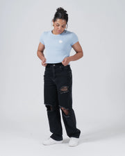 Kingz Kore Women's Baby Tee - Lifestyle Shot - Adjusting Fitted Hem Pose - Baby Blue Women's BJJ Tee [color:Baby Blue]