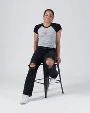 Kingz Gentle Art Club Women's Baby Tee - Lifestyle Shot - Model Seated on Stool - Grey Women's BJJ Tee