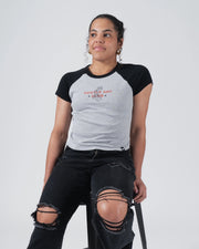 Kingz Gentle Art Club Women's Baby Tee - Lifestyle Shot - Seated Chest Graphic View - Grey Women's BJJ Tee