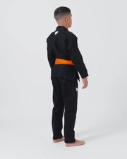 Kingz Kore V2 Youth BJJ Gi Black - Full Body Side Back View Youth Athlete Orange Belt Crown Logo Youth Kids Gi